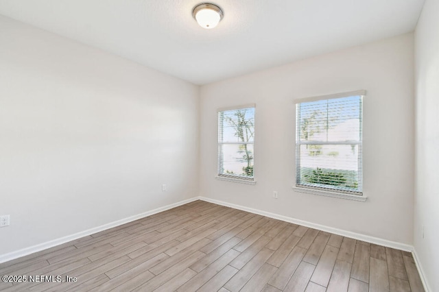 spare room with light hardwood / wood-style flooring