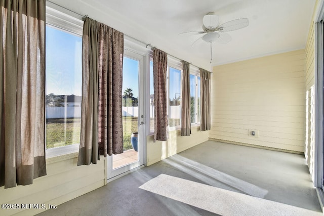 interior space with concrete floors, ceiling fan, and a healthy amount of sunlight