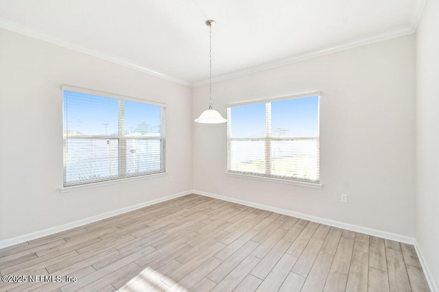 unfurnished room featuring ornamental molding and light hardwood / wood-style floors