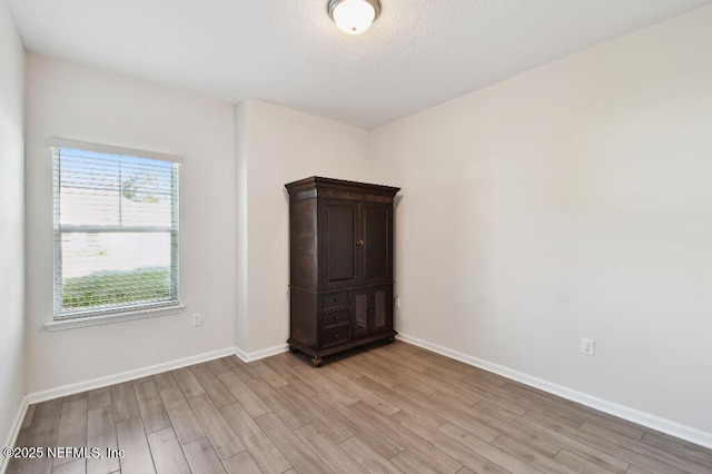 unfurnished room with light wood-type flooring