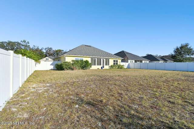 back of house featuring a lawn