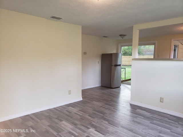 empty room featuring hardwood / wood-style floors and a textured ceiling