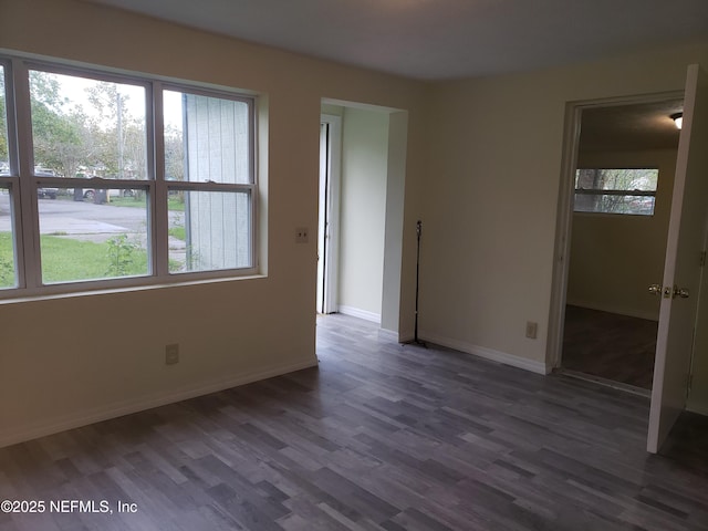 unfurnished room featuring dark wood-type flooring