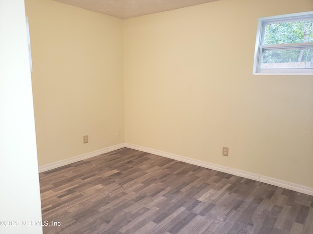 unfurnished room featuring dark hardwood / wood-style floors