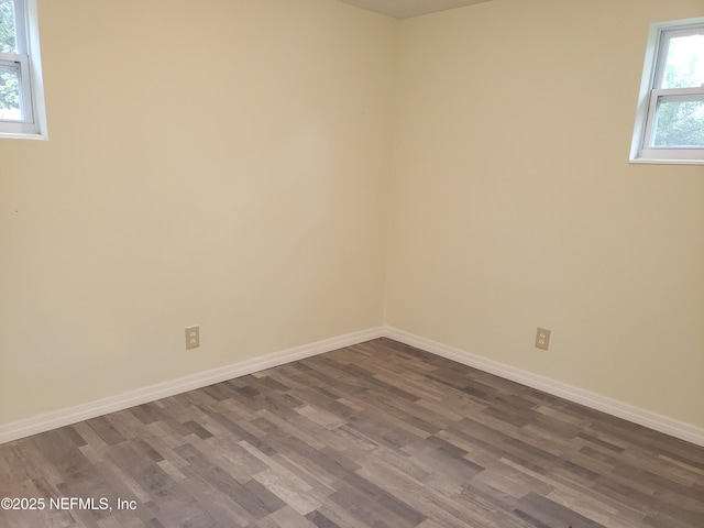 unfurnished room featuring dark hardwood / wood-style floors