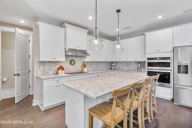 kitchen featuring white cabinets, stainless steel appliances, and a kitchen island