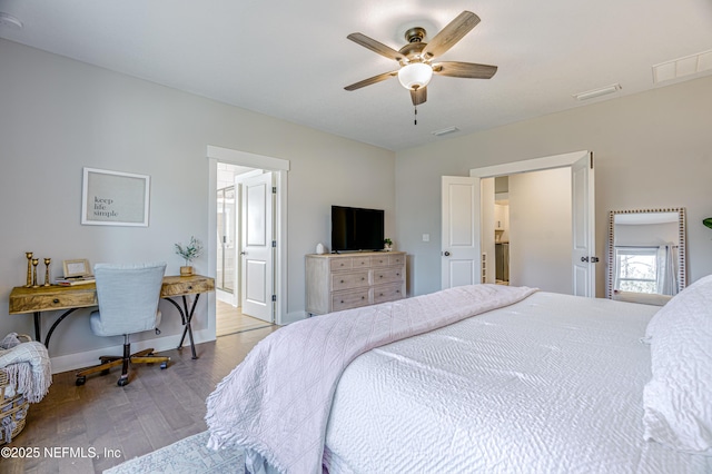 bedroom featuring light wood-type flooring, ceiling fan, and ensuite bath