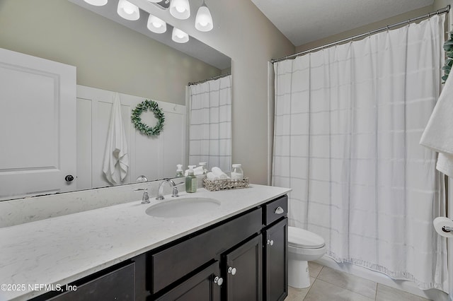 bathroom featuring toilet, vanity, tile patterned flooring, a textured ceiling, and curtained shower