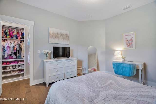 bedroom featuring dark hardwood / wood-style floors and a closet