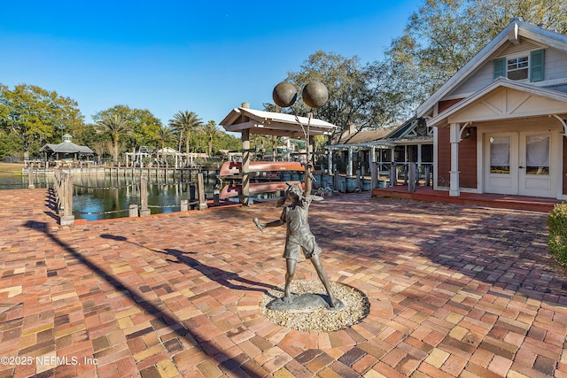 dock area featuring a water view and a patio