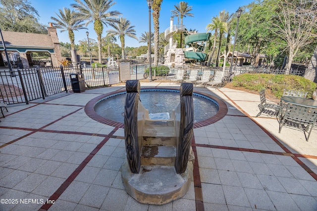 view of pool with a patio area and a playground