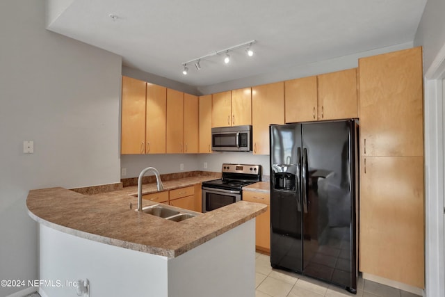 kitchen with kitchen peninsula, light brown cabinetry, light tile patterned floors, appliances with stainless steel finishes, and sink