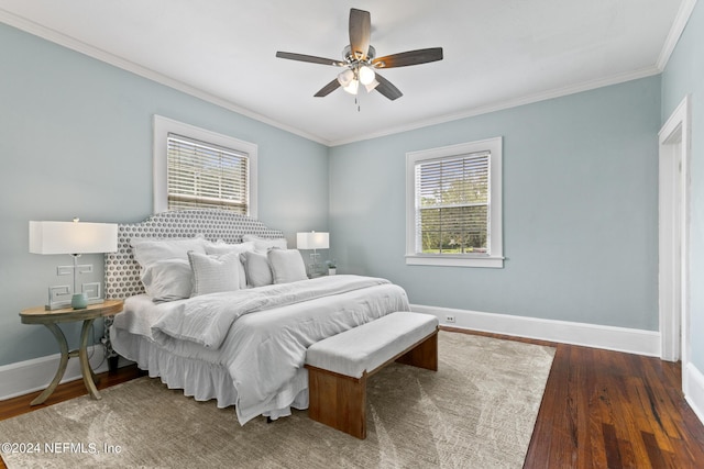 bedroom featuring dark hardwood / wood-style floors, ceiling fan, and crown molding