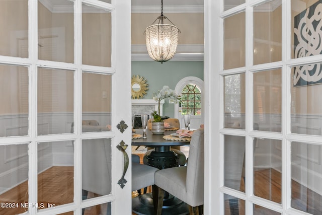 interior space with crown molding and a chandelier