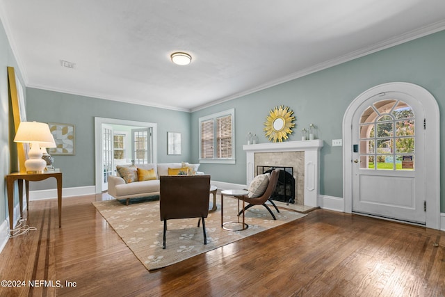 living room with hardwood / wood-style flooring and crown molding