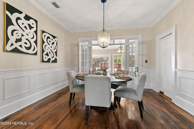 dining room featuring french doors, dark wood-type flooring, a notable chandelier, and ornamental molding