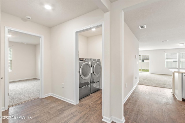 laundry room featuring hardwood / wood-style flooring and washing machine and clothes dryer