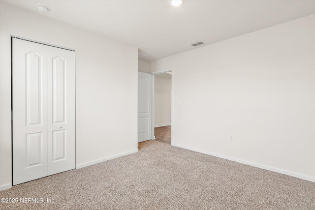 unfurnished bedroom featuring carpet floors and a closet