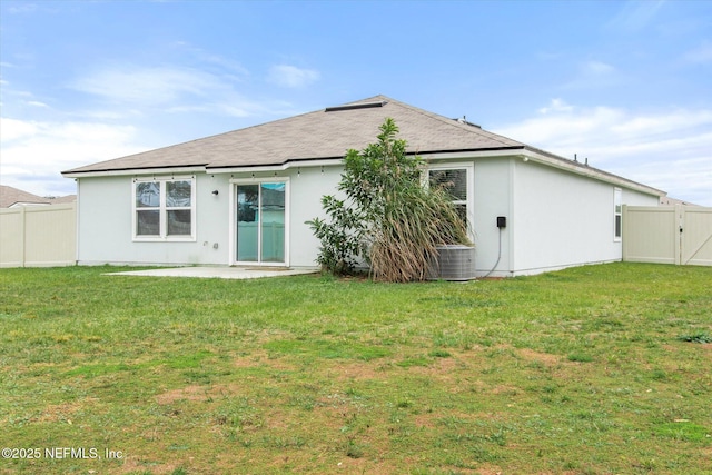 rear view of property with a yard