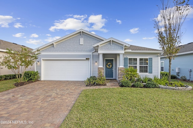 view of front facade with a garage and a front lawn