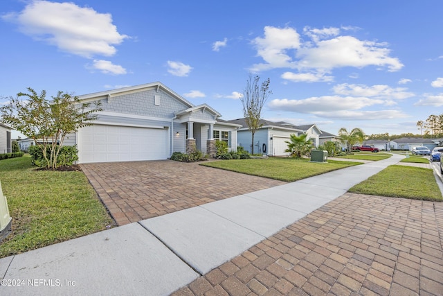 ranch-style home with a front yard and a garage