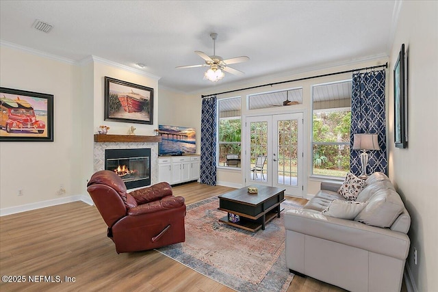 living room featuring ceiling fan, french doors, crown molding, and wood-type flooring