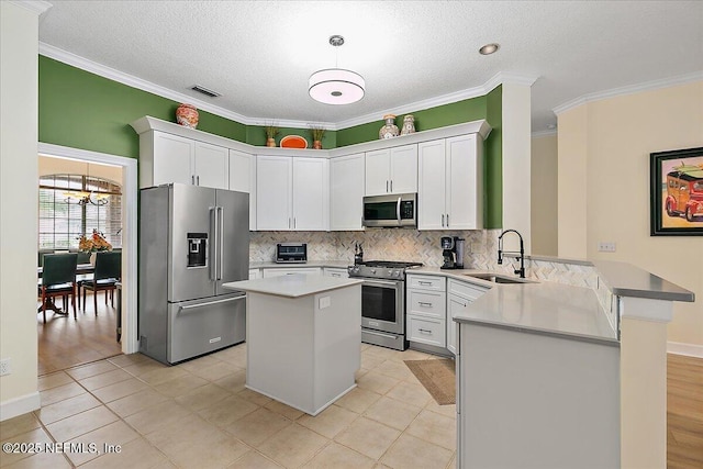 kitchen featuring sink, white cabinets, kitchen peninsula, and high quality appliances