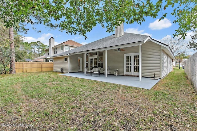 rear view of house featuring ceiling fan, french doors, a yard, and a patio area