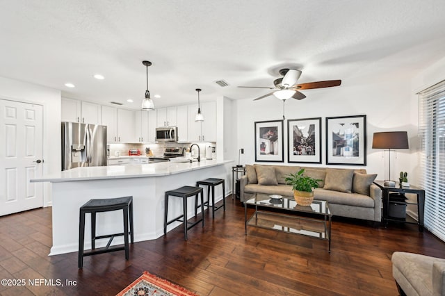 interior space with dark wood-type flooring, sink, and a textured ceiling