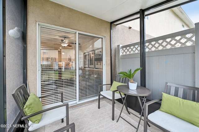 sunroom featuring ceiling fan