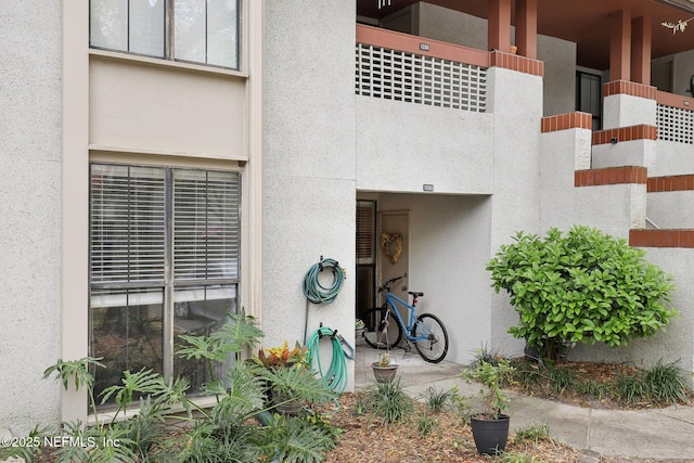 entrance to property with stucco siding