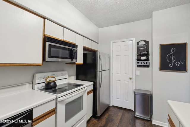 kitchen with a textured ceiling, stainless steel appliances, white cabinets, light countertops, and dark wood-style flooring