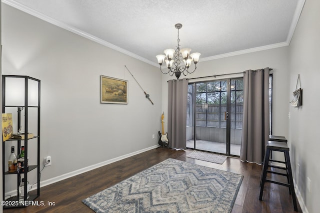 sitting room with baseboards, crown molding, an inviting chandelier, and wood finished floors