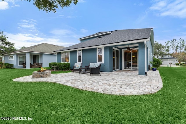 back of house featuring an outdoor living space with a fire pit, ceiling fan, a yard, and a patio