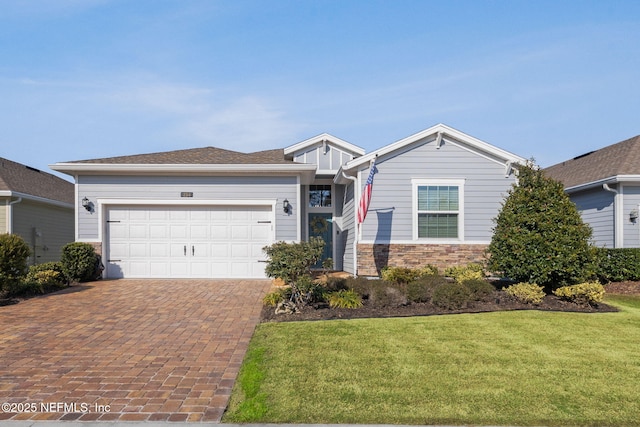 view of front of house featuring a garage and a front lawn