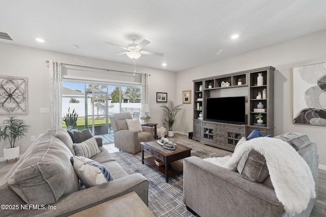 living room with ceiling fan and wood-type flooring