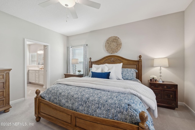 bedroom with ensuite bath, ceiling fan, and light colored carpet