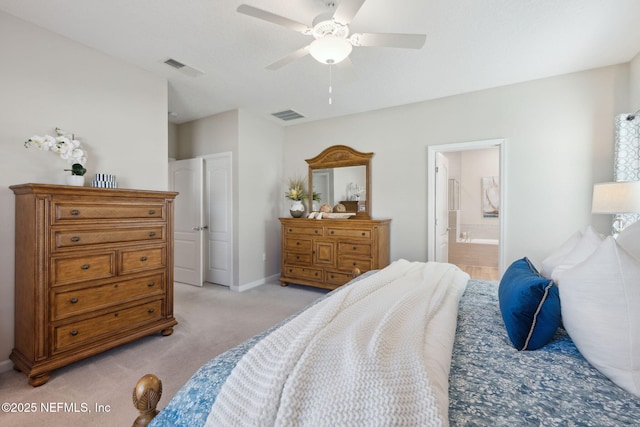 bedroom featuring ensuite bathroom, ceiling fan, and light colored carpet