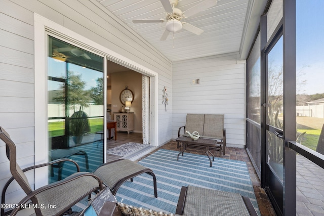 sunroom / solarium featuring a wealth of natural light and ceiling fan