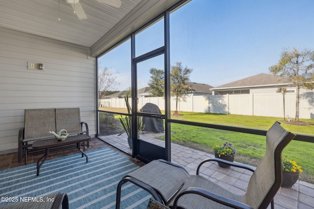 sunroom featuring ceiling fan