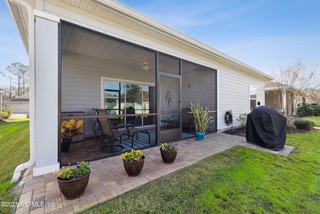 back of property featuring a sunroom and a yard