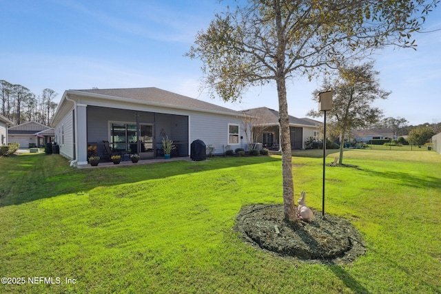 rear view of property featuring a yard