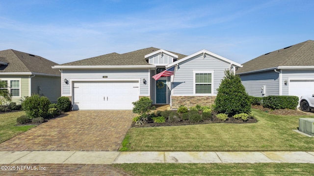 view of front facade with a front yard and a garage