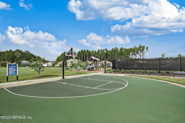 view of basketball court with a lawn and a playground