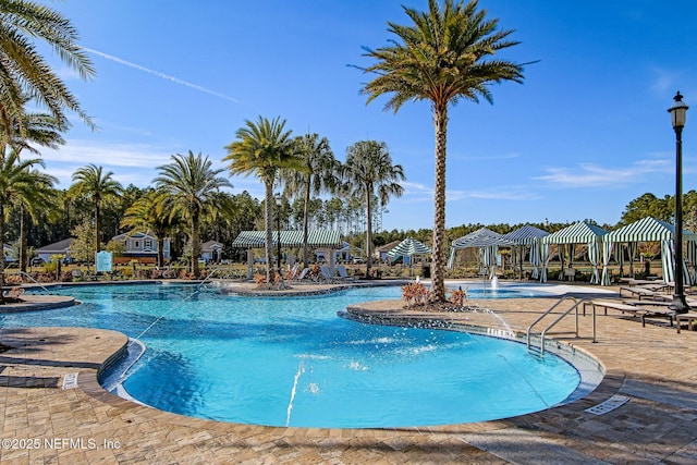 view of pool featuring a gazebo, pool water feature, and a patio area