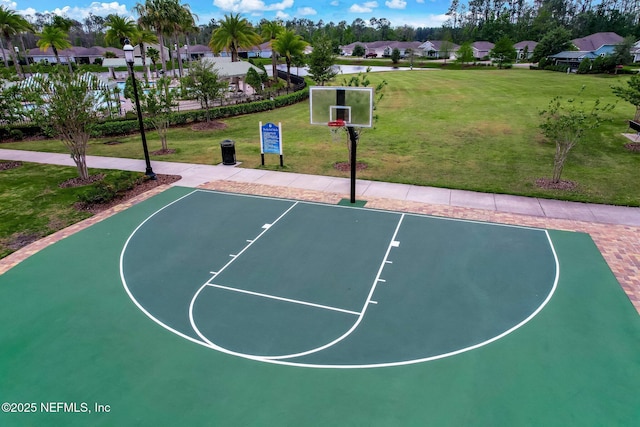 view of sport court featuring a yard