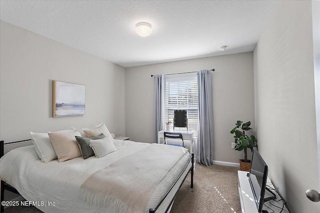 bedroom featuring a textured ceiling, baseboards, and carpet