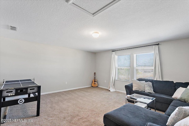 living area with visible vents, baseboards, attic access, and carpet flooring