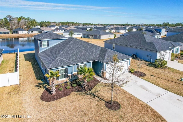 bird's eye view featuring a residential view and a water view