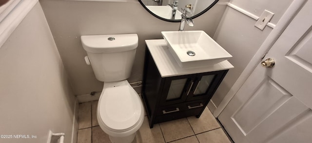 bathroom with toilet, tile patterned floors, and vanity